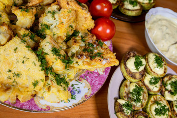 homemade cauliflower in batter and zucchini with tartar sauce and tomatoes