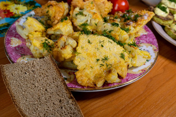 homemade cauliflower in batter and zucchini with tartar sauce and tomatoes