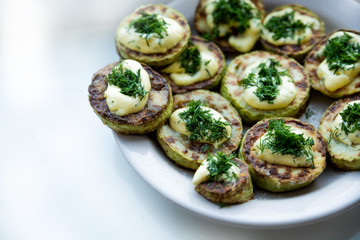 homemade zucchini fried with mayonnaise. On a white background