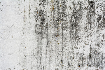 texture of an old wall with uneven cracked stucco, dirty surface of the exterior painted wall