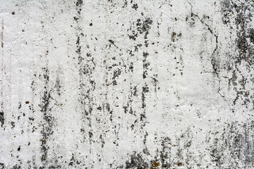 texture of an old wall with uneven cracked stucco, dirty surface of the exterior painted wall