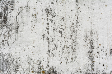 texture of an old wall with uneven cracked stucco, dirty surface of the exterior painted wall