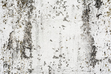 texture of an old wall with uneven cracked stucco, dirty surface of the exterior painted wall