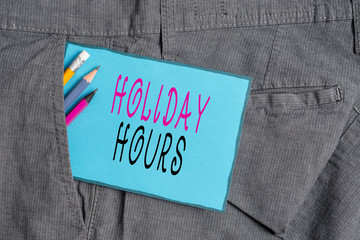 Conceptual hand writing showing Holiday Hours. Concept meaning employee receives twice their normal pay for all hours Writing equipment and blue note paper in pocket of trousers