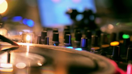 Close Up of DJ Hands Mixing Music using Control Buttons on Professional Turntable Deck Console in Night Club at Disco Party. 4K Background Stock Footage