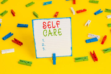 Handwriting text Self Care. Conceptual photo the practice of taking action to improve one s is own health Colored clothespin papers empty reminder yellow floor background office