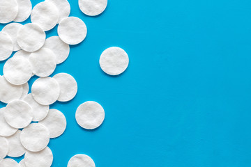 Hygiene cotton pads for pattern on blue background top view copyspace