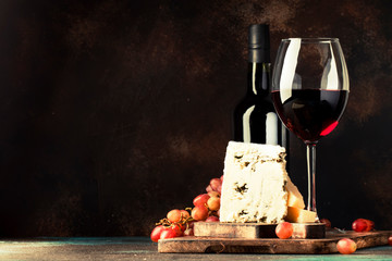 Port wine and blue cheese, still life in rustic style, vintage wooden table background, selective...