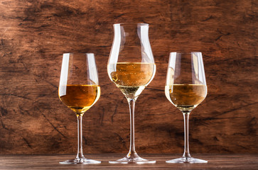 White wine set. Wine tasting, the most popular varieties of white wines in wine glasses on vintage wooden table in rustic style, selective focus
