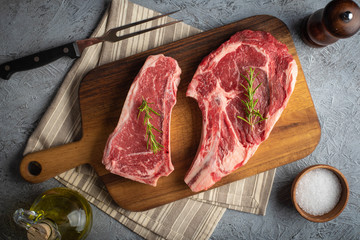 raw beef steak, new york strip steak and ribeye
