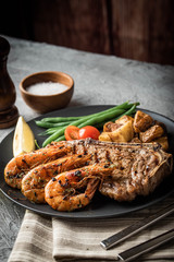surf and turf, new york strip steak and grilled prawn