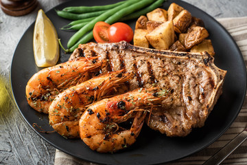 surf and turf, new york strip steak and grilled prawn