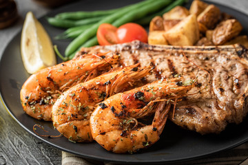 surf and turf, new york strip steak and grilled prawn