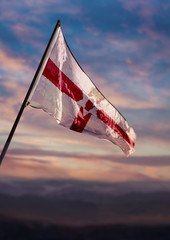 Northern Ireland flag, Irish flag waving on sky at dusk