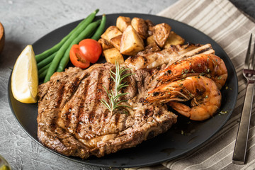 surf and turf, ribeye steak and grilled prawn