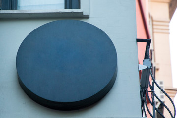 black round blank signboard hanging on wall.mockup signboard 3d rendering