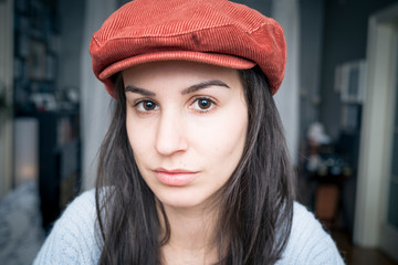 Portrait of beautiful young woman wearing red hat 