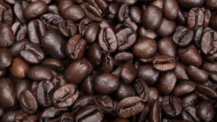 Roasted coffee beans background. Macro photography of coffee beans.