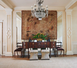 Interior view of entryway with tapestry and chandelier