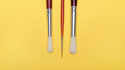 Set of brushes for painting isolated on a yellow background