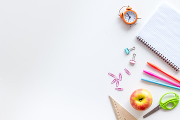 Education mockup with pupil's stationery, clock, apple and textbook on white background top view