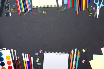 Back to school concept. School supplies double border on a chalkboard background.