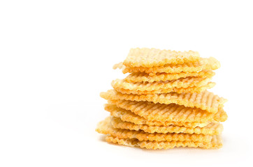 Natural corrugated potato chips on white background. Copy space.