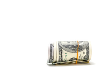 Twisted bundle of 100 dollar bills isolated on white background.