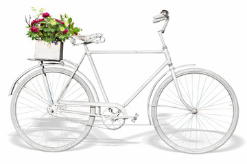 A white decorative bicycle with a box of flowers on white background, isolated.