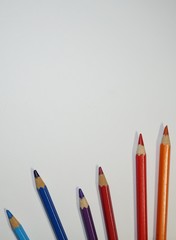 Multicolored pencils on white background.