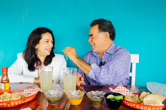 Hispanic Mexican Senior Couple Eating At Restaurant  In Mexico