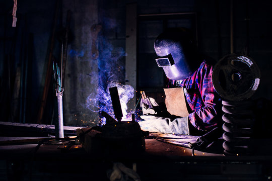Welder working in workshop