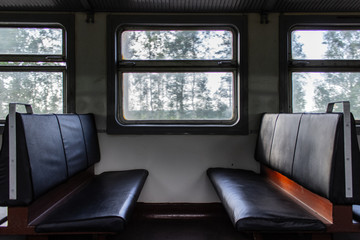 Empty seats inside passenger car of old electrical train