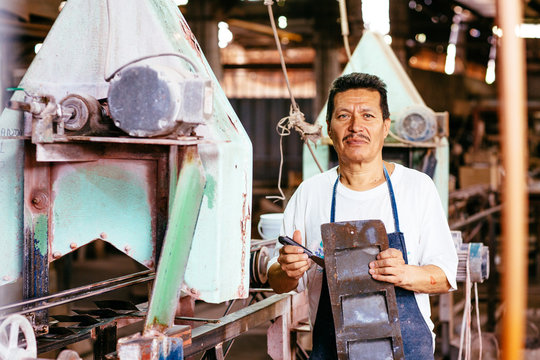Man holding iron sheet