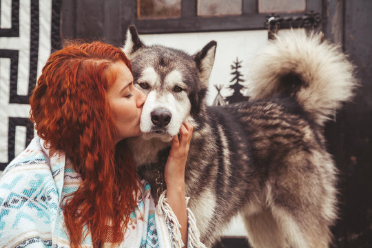 Girl With Her Dog Malamute Near Round Home Far Away From Civilization In The Woods