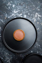 Chocolate tartlets on  a Black gres kitchenwares arranged over a beautiful  black stanned   background, top view  composition