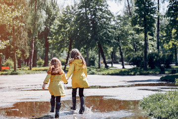 Obraz premium Kids in a rain coats. Children in a park.