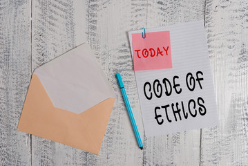 Writing note showing Code Of Ethics. Business concept for basic guide for professional conduct and imposes duties Envelope blank sheet sticky note ballpoint wooden background