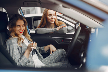 Women buying the car. Ladies in a car salon