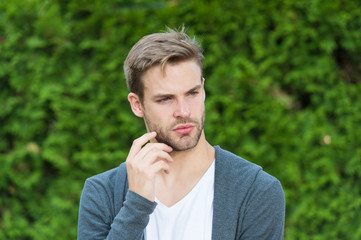 Handsome caucasian man nature green background. Bearded guy casual style. Barbershop service....