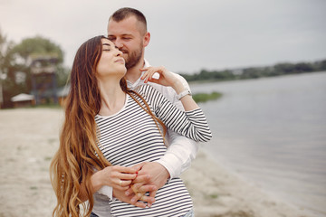 Couple in a park. Woman with long curly hair. Man with his wife