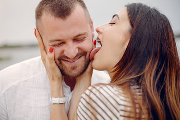 Couple in a park. Woman with long curly hair. Man with his wife