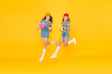 Fototapeta premium Lets study. Back to school. Excited about studying. Study groups help students learn material deeper. Kids girls with books study together. Generate positive energy, encourage active participation