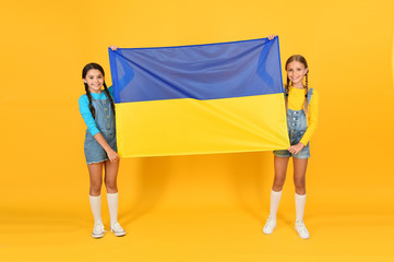 National identity concept. Ukrainian kids. Girls with blue and yellow flag. Patriotic education. Happy independence day. Children hold ukrainian flag. Patriotism respect and love to motherland