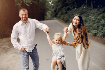 Fototapeta premium Family in a summer park. Mother and little daughter playing. Cute little girl with a father