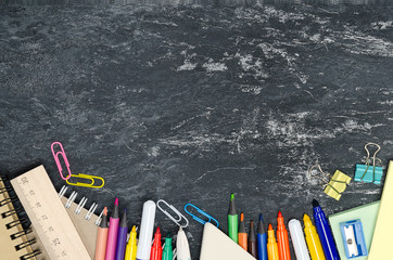 School supplies on blackboard background. School concept copy space for design.