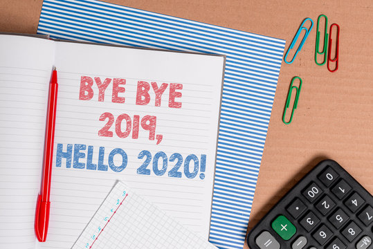 Word writing text Bye Bye 2019 Hello 2020. Business photo showcasing saying goodbye to last year and welcoming another good one Striped paperboard notebook cardboard office study supplies chart paper