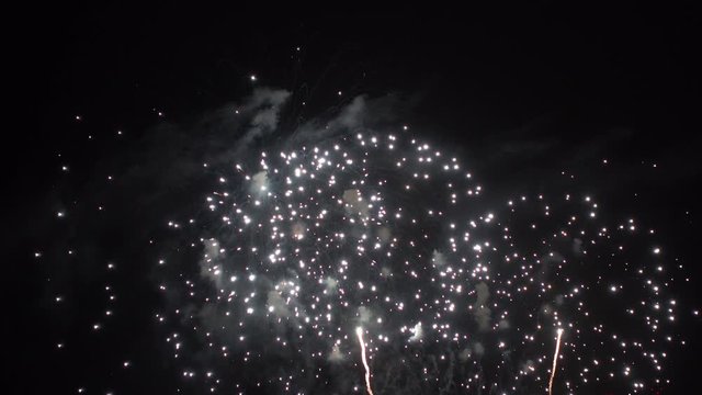 Firework display with large rockets in night sky