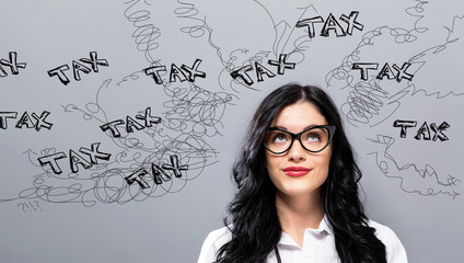 Tax problem theme with young businesswoman in a thoughtful face - obrazy, fototapety, plakaty