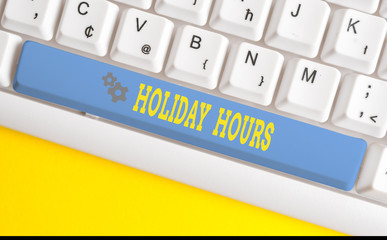Text sign showing Holiday Hours. Business photo text employee receives twice their normal pay for all hours White pc keyboard with empty note paper above white background key copy space
